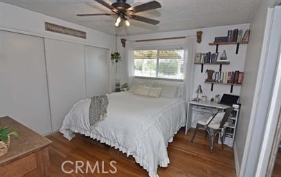 21825 Thunderbird Road Apple Valley, CA 92307 - Photo 15 of 22 a bedroom with a bed and a chandelier