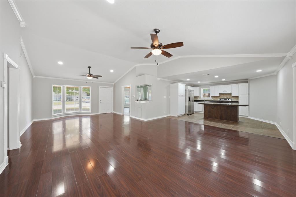 1108 Billie Ruth Lane Hurst, TX 76053 - Photo 6 of 27 Expansive living area featuring rich wood-finish flooring, recessed lighting, and vaulted ceilings