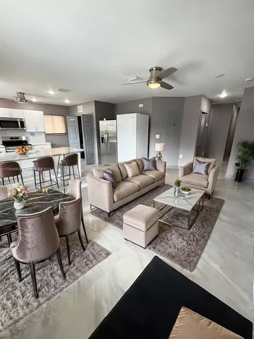 a living room with furniture and a chandelier