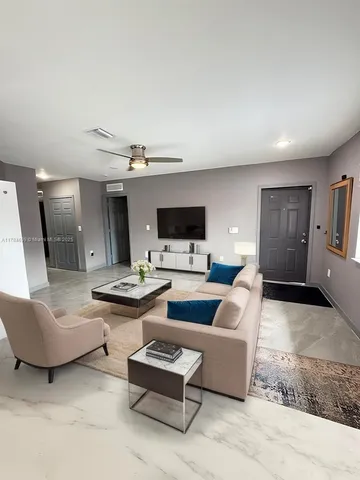 a living room with furniture and a flat screen tv