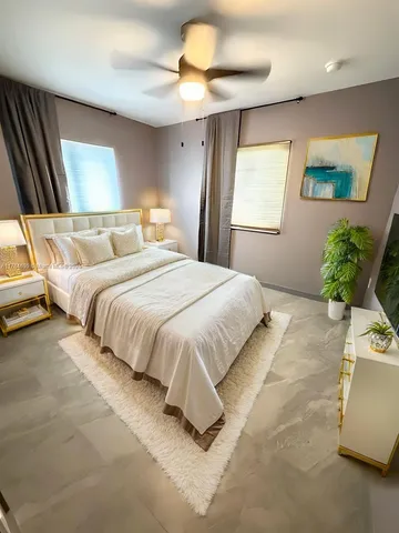 a bedroom with a bed and a chandelier