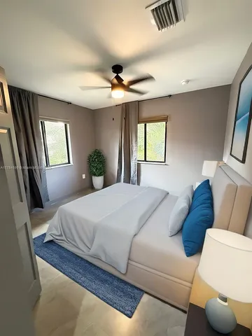 a bedroom with a bed couch and window