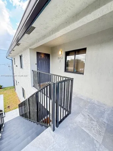 a view of a porch with wooden floor and fence