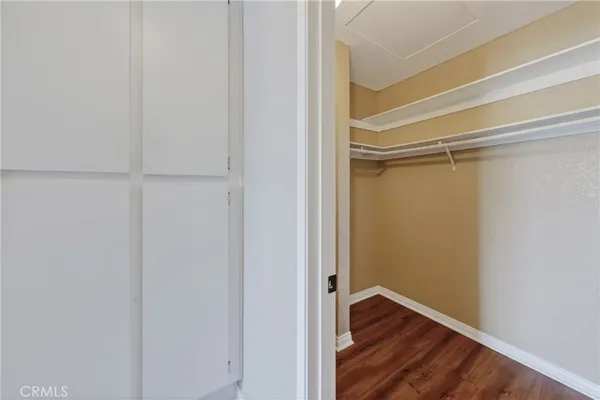 a view of closet area with wooden floor