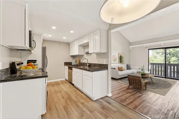 a kitchen with granite countertop lots of counter top space and stainless steel appliances