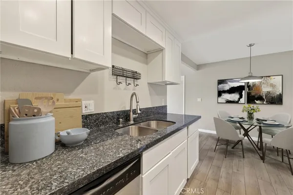 a kitchen with stainless steel appliances granite countertop a sink and a stove