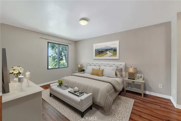 a bedroom with a bed and a night stand