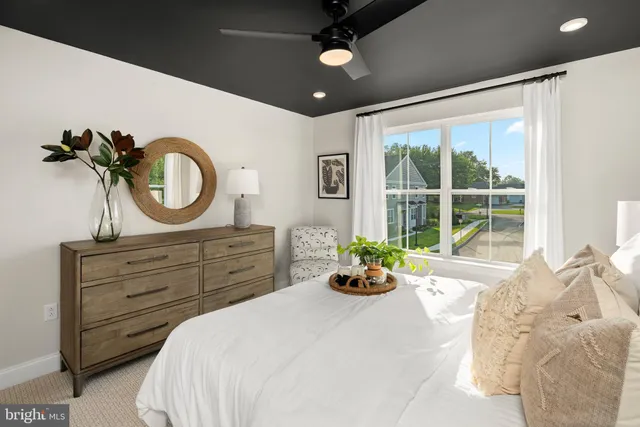 a bed room with a bed and a large window