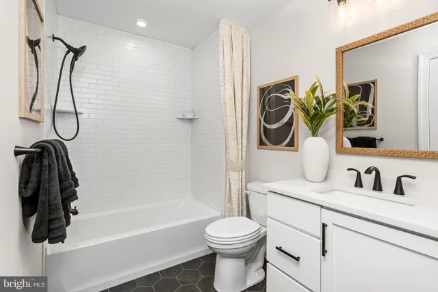 a view of a hallway of a livingroom with furniture and a window