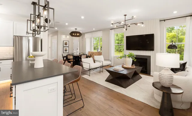 a kitchen with stainless steel appliances granite countertop a kitchen island a stove a table and chairs