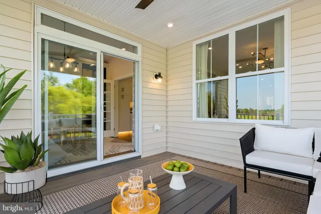 a living room with a fireplace furniture and a floor to ceiling window