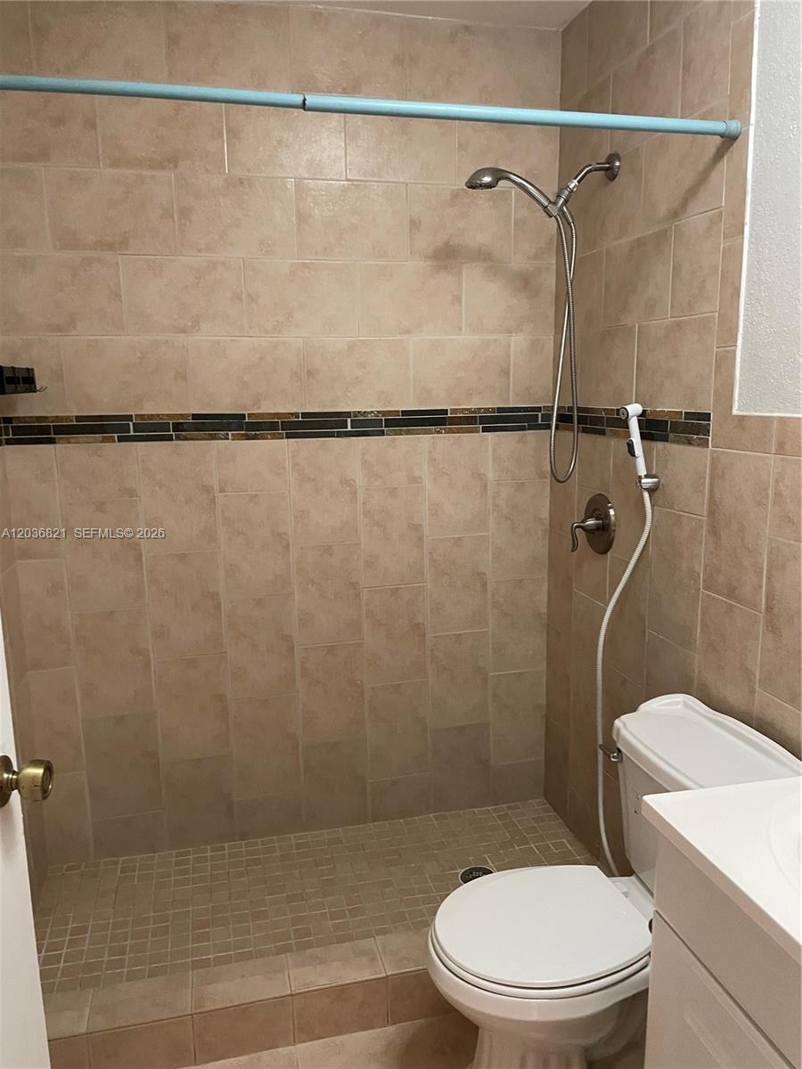 14770 Southwest 60th Street Miami, FL 33193 - Photo 16 of 16 a white toilet sitting next to a bath tub