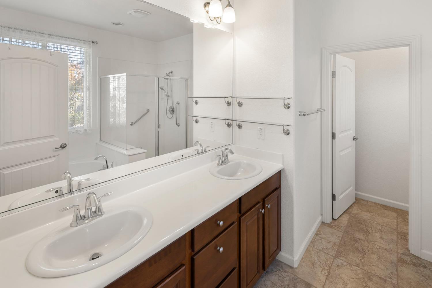 3451 Rainhill Loop Roseville, CA 95747 - Photo 17 of 40 a bathroom with a sink double vanity and a mirror