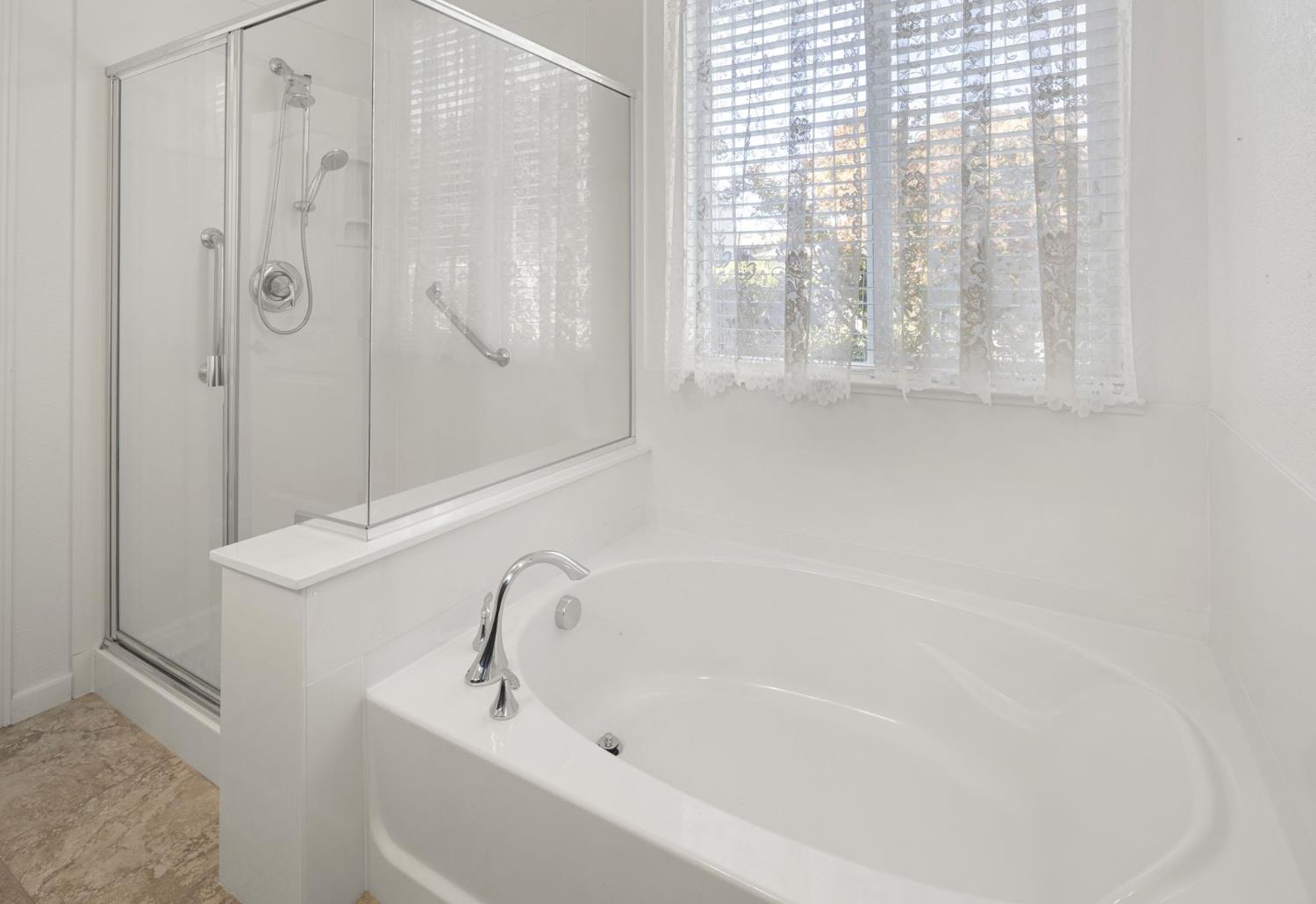 3451 Rainhill Loop Roseville, CA 95747 - Photo 18 of 40 a bathroom with a bathtub and a shower