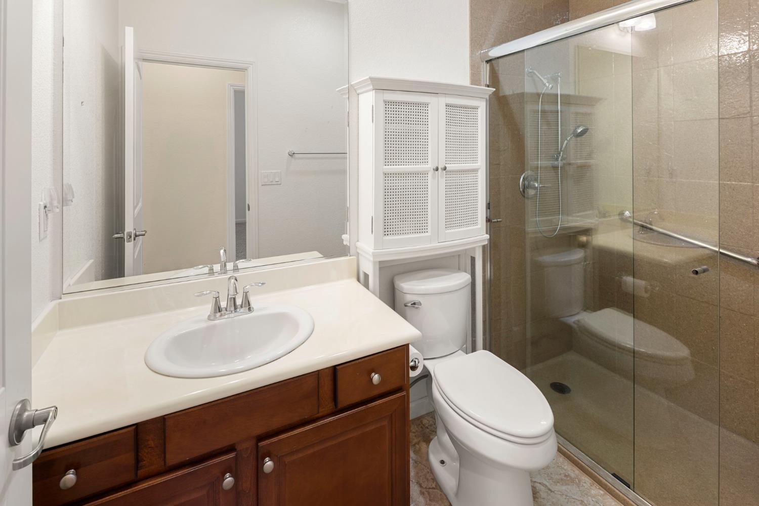 3451 Rainhill Loop Roseville, CA 95747 - Photo 23 of 40 a bathroom with a sink a toilet and shower