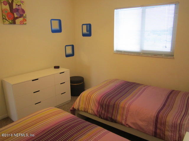 4 Ocean Trace Road, Unit 422 St. Augustine, FL 32080 - Photo 16 of 33 a bedroom with a bed and a window