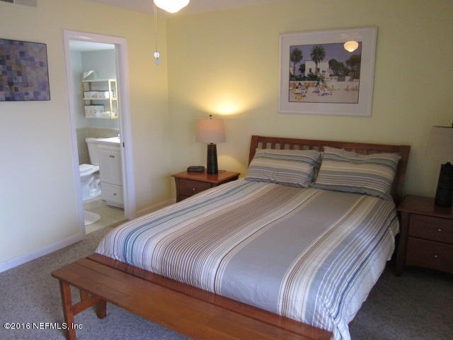 4 Ocean Trace Road, Unit 422 St. Augustine, FL 32080 - Photo 21 of 33 a bedroom with a bed and bathroom