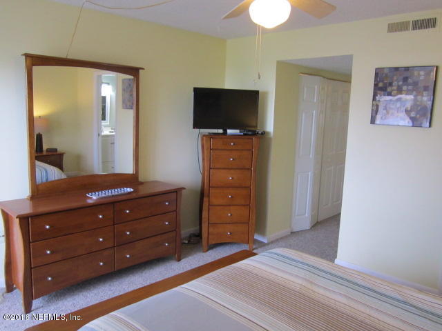 4 Ocean Trace Road, Unit 422 St. Augustine, FL 32080 - Photo 22 of 33 a room with a bed and a flat tv screen on dresser
