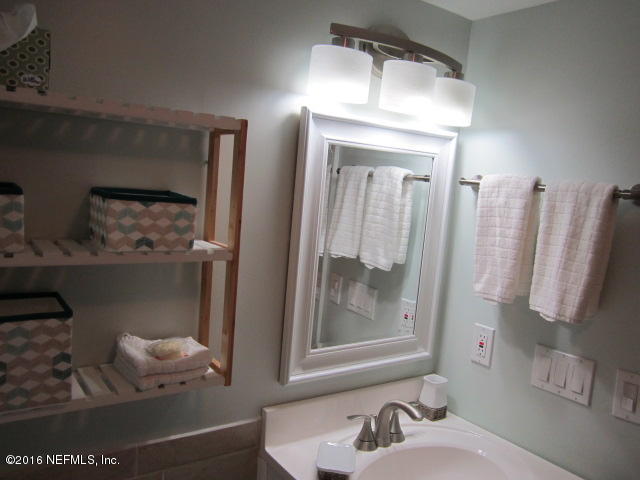 4 Ocean Trace Road, Unit 422 St. Augustine, FL 32080 - Photo 27 of 33 a bathroom with a sink and a mirror