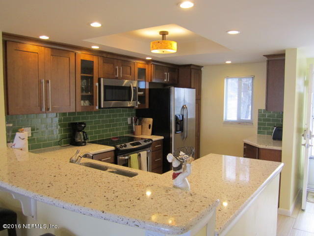 4 Ocean Trace Road, Unit 422 St. Augustine, FL 32080 - Photo 6 of 33 a kitchen with a sink a refrigerator and a stove