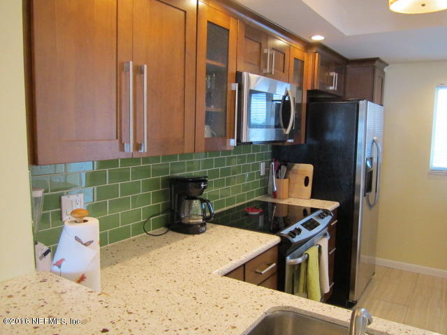 4 Ocean Trace Road, Unit 422 St. Augustine, FL 32080 - Photo 7 of 33 a kitchen with a sink and a stove top oven