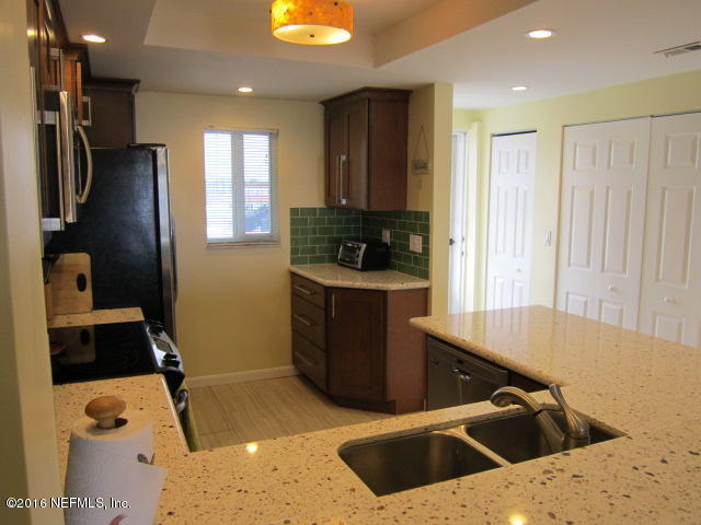 4 Ocean Trace Road, Unit 422 St. Augustine, FL 32080 - Photo 8 of 33 a kitchen that has a sink and a stove in it