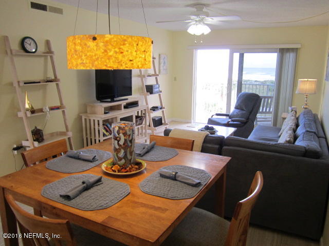 4 Ocean Trace Road, Unit 422 St. Augustine, FL 32080 - Photo 9 of 33 a living room with furniture a flat screen tv and a large window
