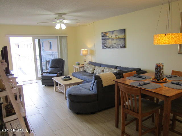 4 Ocean Trace Road, Unit 422 St. Augustine, FL 32080 - Photo 10 of 33 a living room with furniture a flat screen tv and a window