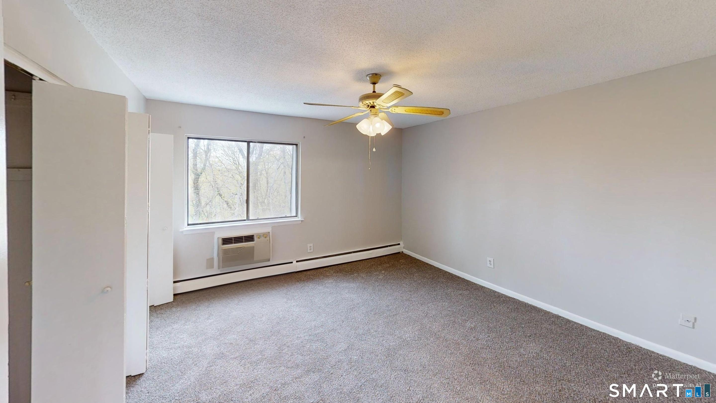 158 High Path Road, Unit 158 Windsor, CT 06095 - Photo 15 of 20 an empty room with windows and fan