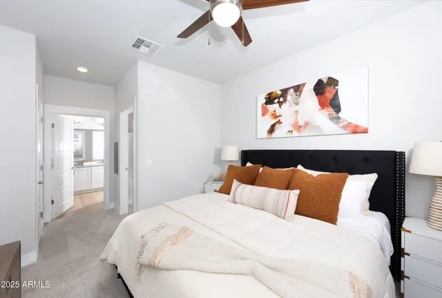 a bedroom with a bed and painting on the wall