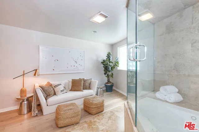 a view of a hallway with wooden floor and a potted plant
