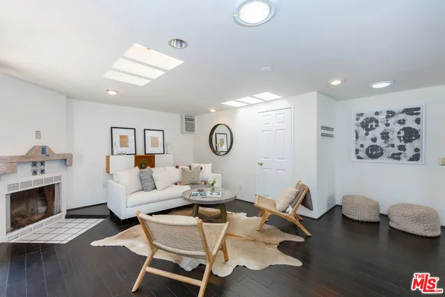 a living room with furniture and a mirror