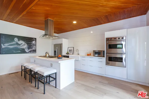 a view of kitchen with cabinets and wooden floor