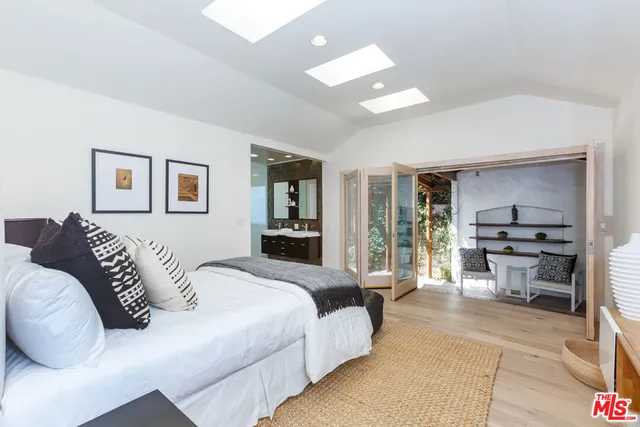 a bedroom with a large bed and a couch