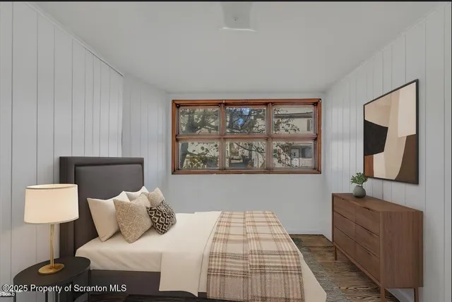 a bedroom with a bed and lamp