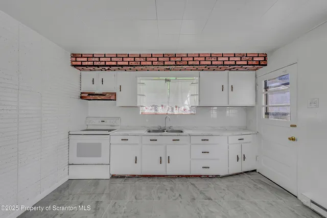 a kitchen with stainless steel appliances kitchen island granite countertop a sink and cabinets