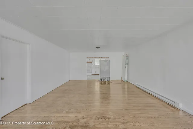 a living room with furniture a fireplace and a window