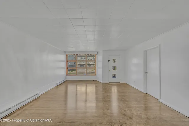 a living room with furniture a rug and a flat screen tv