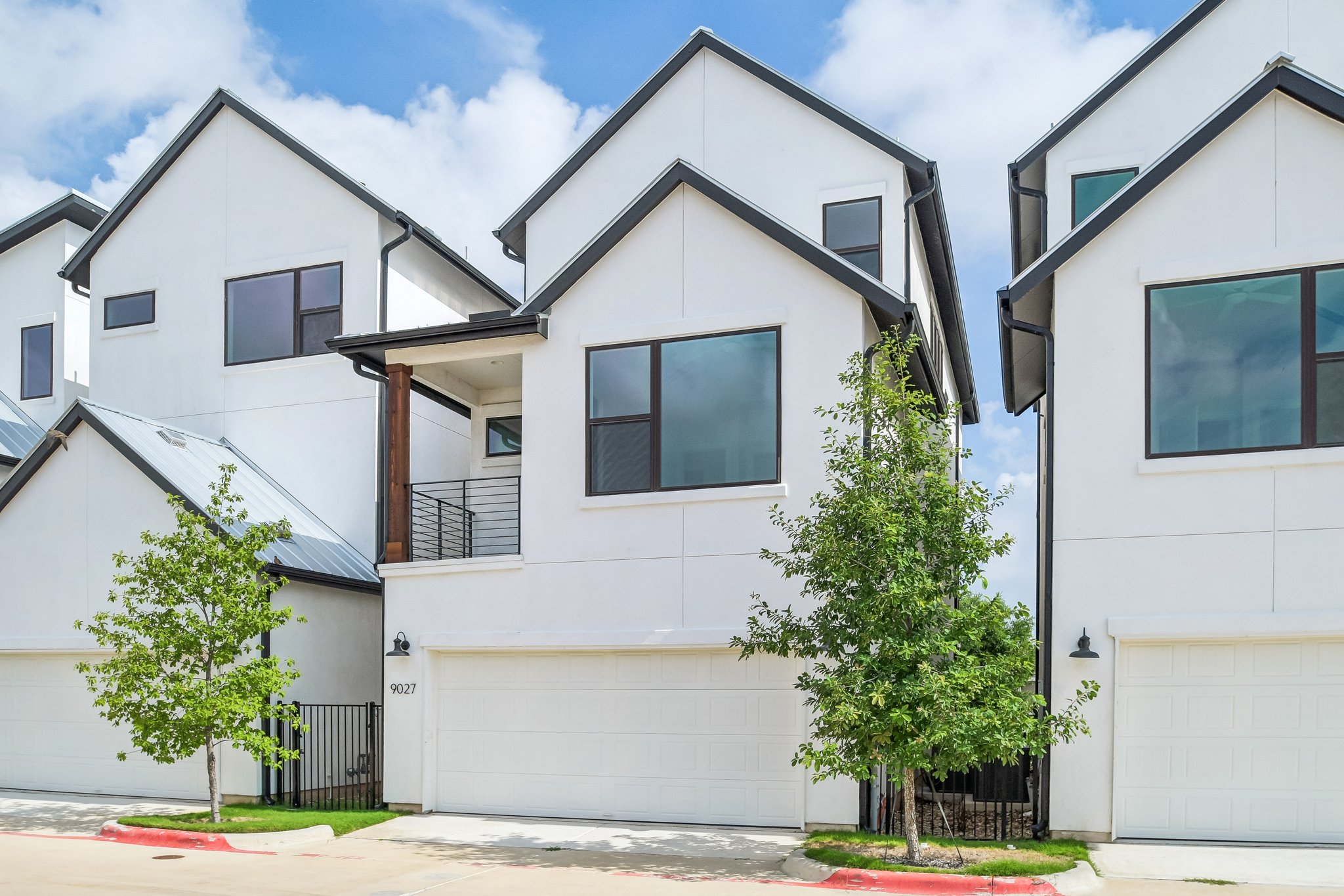 9027 Cattle Baron Path Austin, TX 78747 - Photo 28 of 32 Clean lines and ample windows define the appealing curb appeal of these modern townhomes.