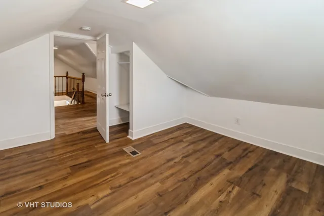 a view of a room with wooden floor