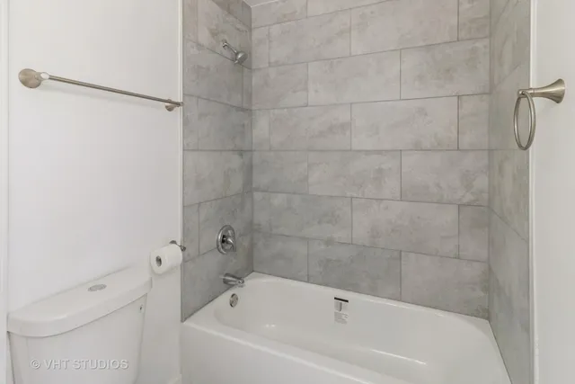 a bathroom with a bathtub and shower