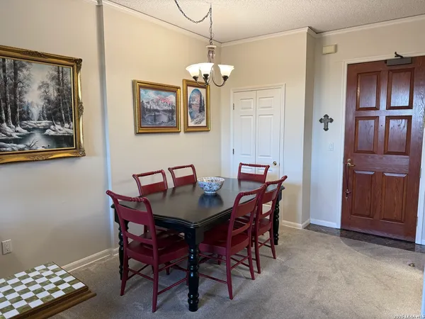 a view of a dining room with furniture and chandelier