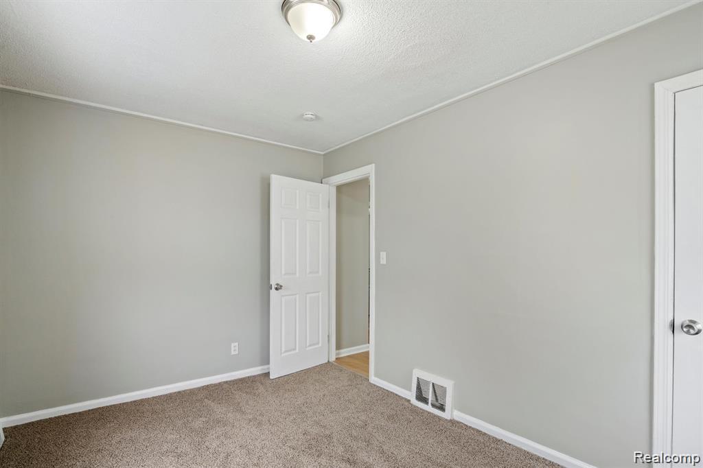 285 Campbell Street River Rouge, MI 48218 - Photo 15 of 33 Carpeted spare room featuring baseboards