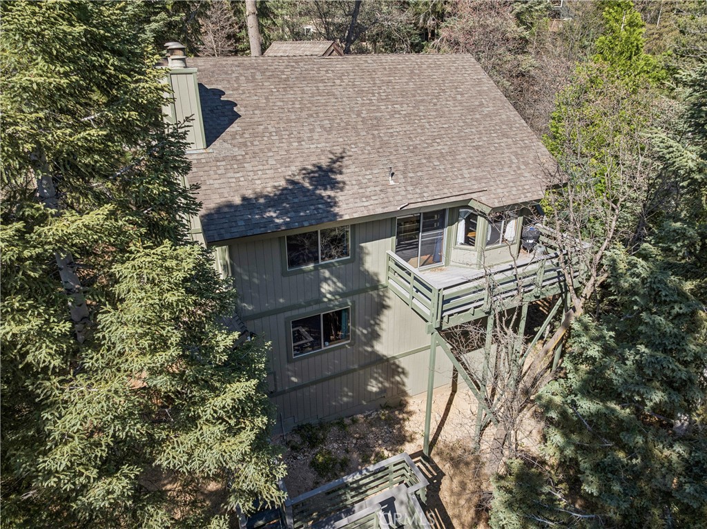 an aerial view of a house with a yard and balcony