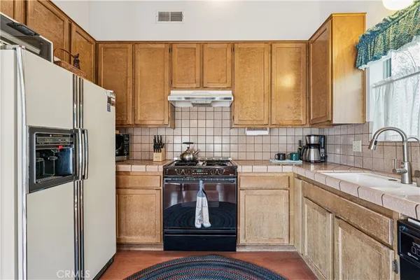 a kitchen with a sink stove and refrigerator