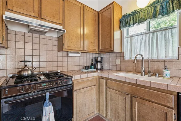 a kitchen with a sink cabinets and appliances