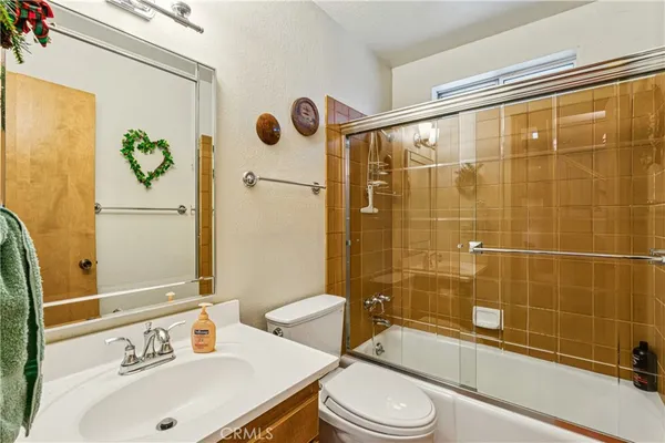 a bathroom with a sink mirror toilet and bathtub