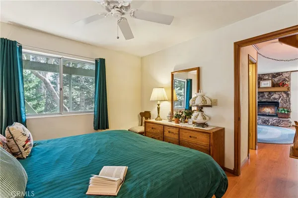 a bedroom with a bed and large windows