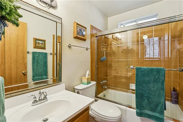 a bathroom with a sink mirror toilet and shower