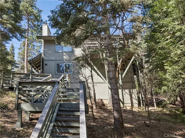 an aerial view of a house with a garden and mountain view